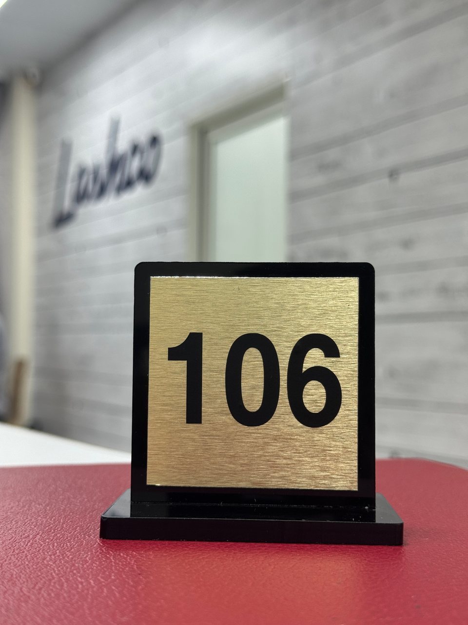 A freestanding number display with a gold-coloured face.